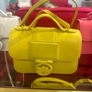 Longchamp crossbody and can be carried with handle.